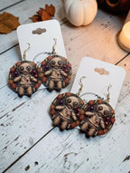 Louisiana Voodoo Doll earrings styled with autumn decor and candle - 3D UV printed Halloween earrings