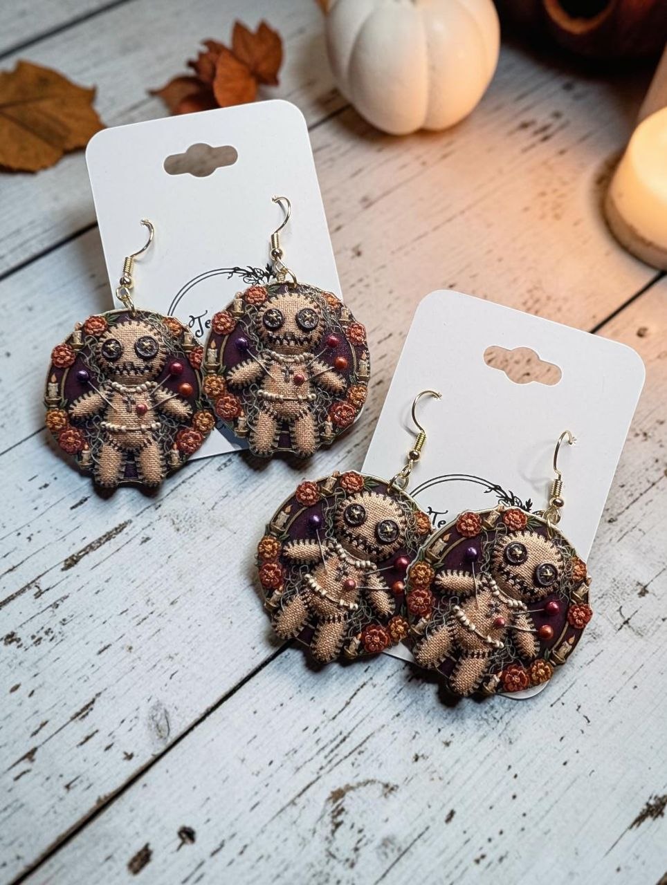 Louisiana Voodoo Doll earrings styled with autumn decor and candle - 3D UV printed Halloween earrings